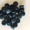 Collection of dark grey silicone rubber end caps used for sealing and protecting pipe ends, tubing, or threaded bolts