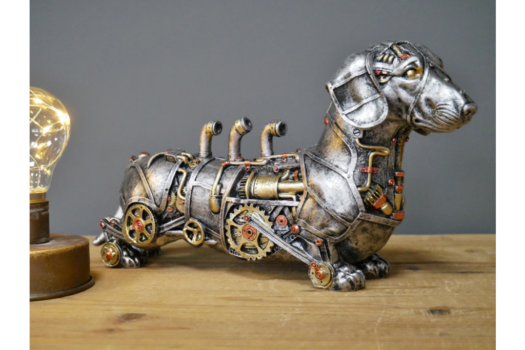 Steampunk dachshund dog sculpture with gears and pipes, silver resin finish, warm bulb background on wooden surface