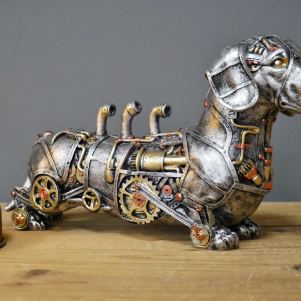 Steampunk dachshund dog sculpture with gears and pipes, silver resin finish, warm bulb background on wooden surface