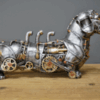 Side view of silver steampunk dachshund sculpture with brass gears, copper pipes, and gothic mechanical design
